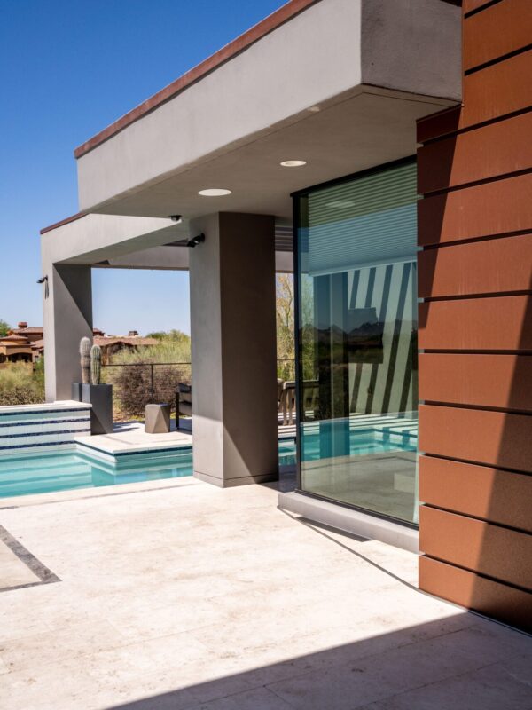 Home 2 Modern brown and gray home exterior with covered patio and pool