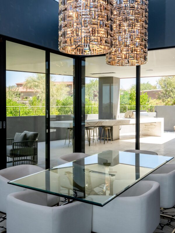 Home 4 Modern dining area with glass table and sculptural pendant lights