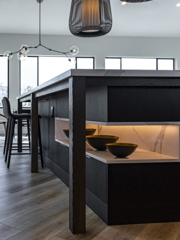 Home 7 modern kitchen island with dark wood cabinetry and integrated display shelving