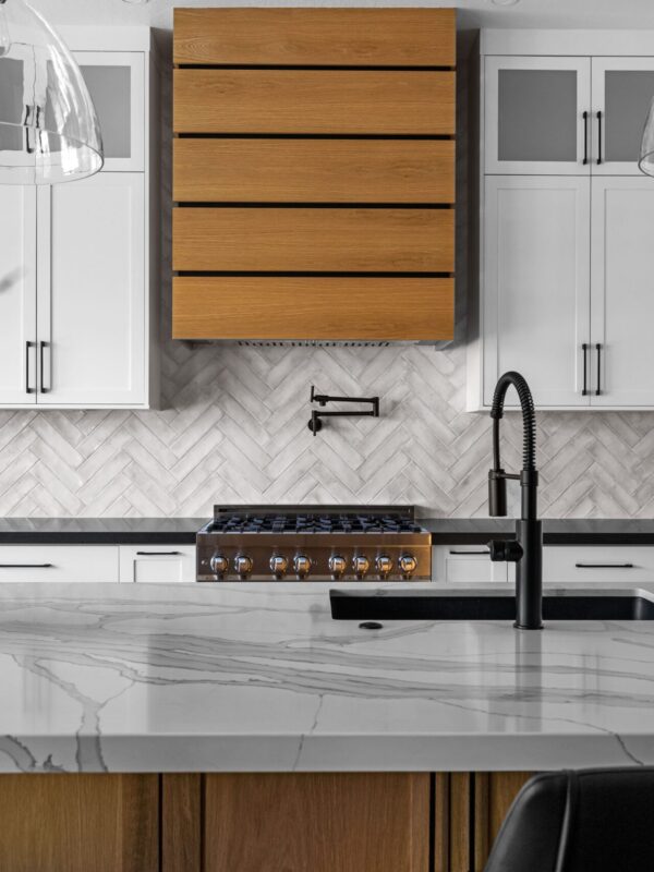 Home 5 Modern kitchen with wood range hood and herringbone tile backsplash
