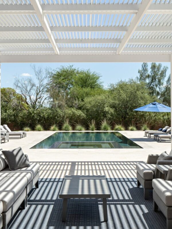 Home 6 trellis over patio furniture in lush backyard